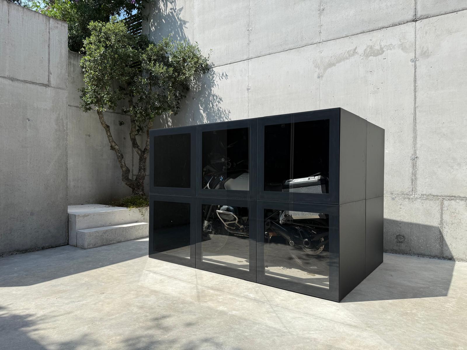 RO. moto vault · a BMW R-series motorcycle visible through smoked glass panels