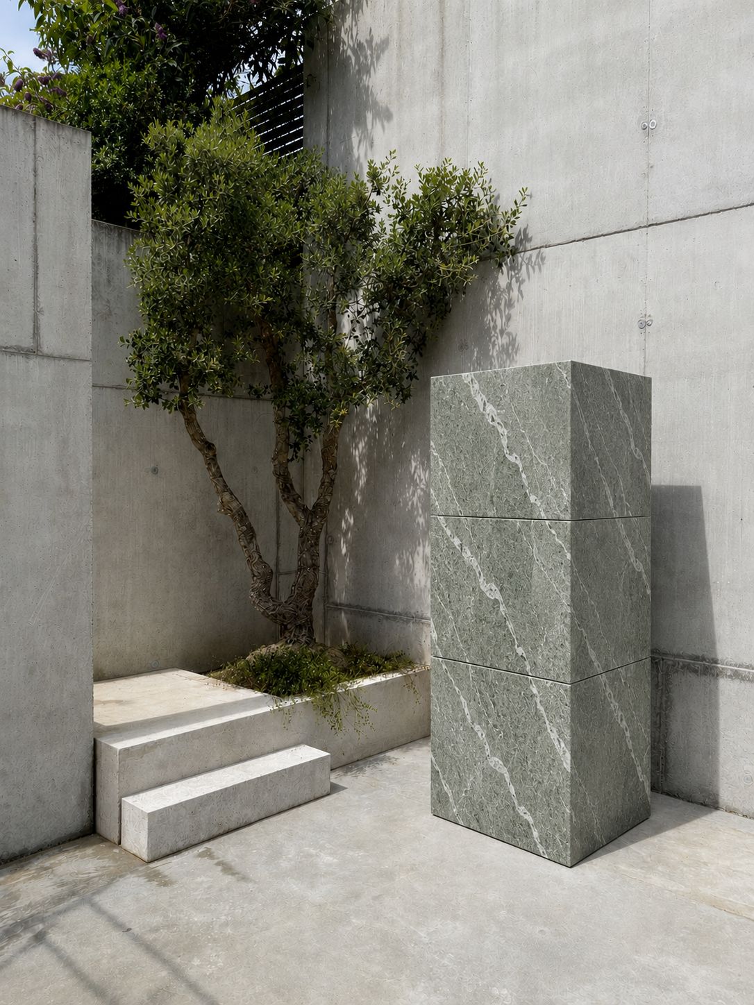 RO. stacked module in veined natural stone next to a concrete bench